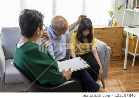 Parents telling the psychologist about family or child problems. Depressed girl and her parent or grandpa having session with psychiatrist in clinic. Parents telling the psychologist about family or child problems. Depressed girl and her parent or grandpa having session with psychiatrist in clinic. 122194846