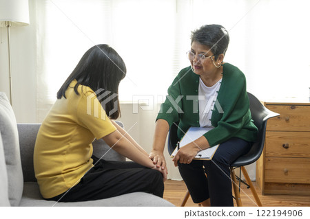 Depressed asian girl having consultation with psychologist at clinic. Depressed asian girl having consultation with psychologist at clinic. 122194906