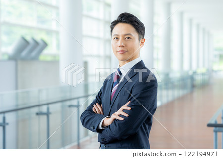 Business people standing in an office corridor Business people standing in an office corridor 122194971