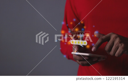 Young Man hand holding Smart Phone with five star to review and give 5 stars Young Man hand holding Smart Phone with five star to review and give 5 stars 122195314