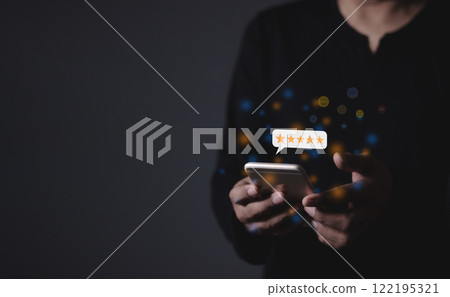 Young Man hand holding Smart Phone with five star to review and give 5 stars Young Man hand holding Smart Phone with five star to review and give 5 stars 122195321