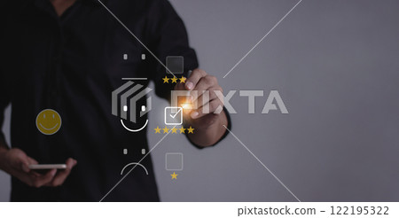 Young man with smartphone mobile hand holding a pen touching to five star to review and give 5 stars 122195322