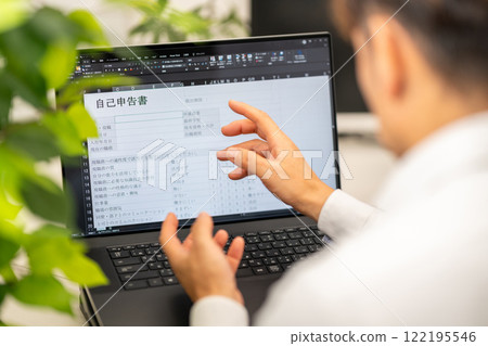 A man filling out a self-declaration form A man filling out a self-declaration form 122195546