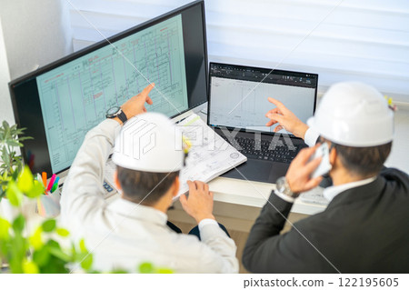 Male chief engineer explaining construction schedule, network schedule, construction supervision, helmet, 2 people Male chief engineer explaining construction schedule, network schedule, construction supervision, helmet, 2 people 122195605