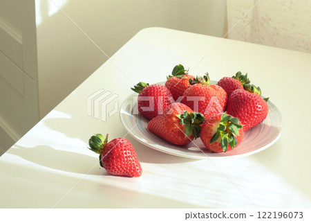 Group of sliced strawberries from home garden on plate. Sun day. Eco-friendly pure natural product. Group of sliced strawberries from home garden on plate. Sun day. Eco-friendly pure natural product. 122196073