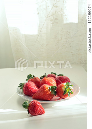 Group of sliced strawberries from home garden on plate. Sun day. Eco-friendly pure natural product. Group of sliced strawberries from home garden on plate. Sun day. Eco-friendly pure natural product. 122196074