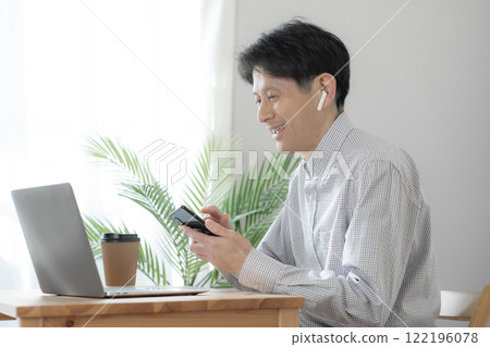 Middle-aged male operator having online conversation, online meeting, remote meeting, telework Middle-aged male operator having online conversation, online meeting, remote meeting, telework 122196078