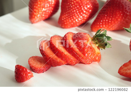 Group of sliced strawberries from home garden on white background. Eco-friendly pure natural product. Group of sliced strawberries from home garden on white background. Eco-friendly pure natural product. 122196082