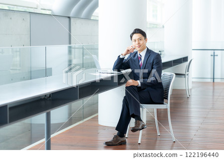 A businessman using a laptop in the office A businessman using a laptop in the office 122196440