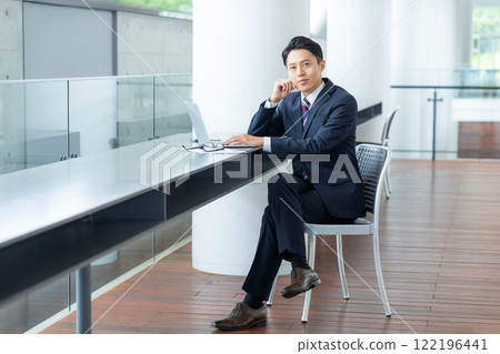 A businessman using a laptop in the office A businessman using a laptop in the office 122196441