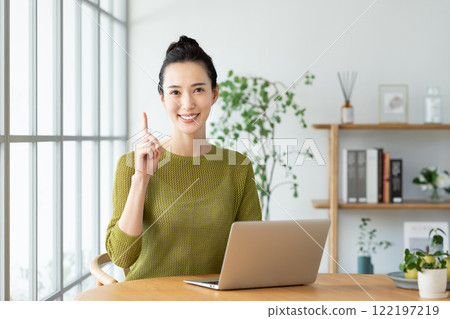 A young woman using a computer at home A young woman using a computer at home 122197219
