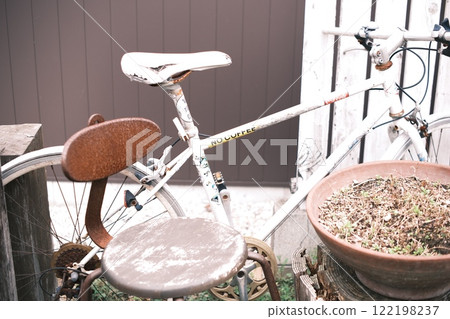 Rusty chair and bike 122198237