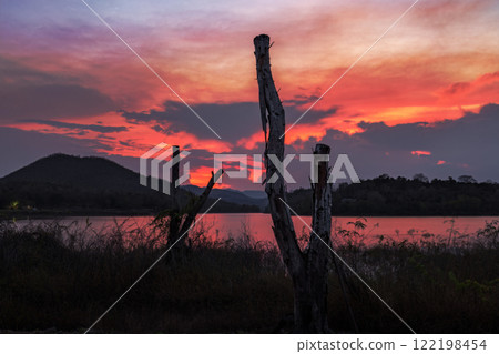 sunset over hills with dramatic sky 122198454