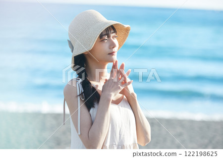 Young woman strolling along the seaside Young woman strolling along the seaside 122198625