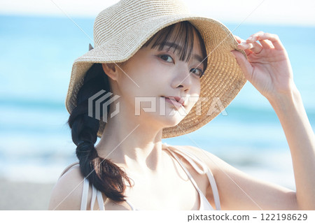 Young woman strolling along the seaside Young woman strolling along the seaside 122198629