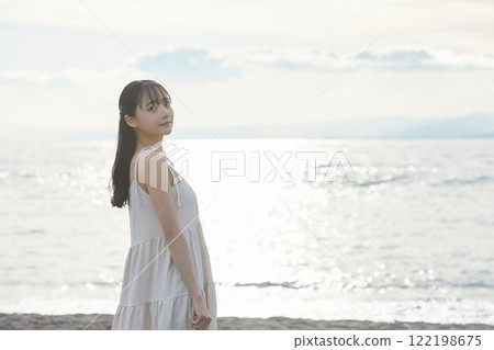 Young woman strolling along the seaside 122198675