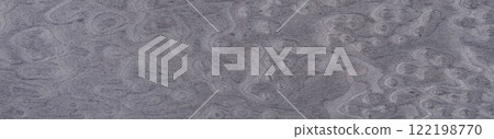 Swirling patterns on a muted gray veneer surface evoke a sense of organic movement Swirling patterns on a muted gray veneer surface evoke a sense of organic movement 122198770