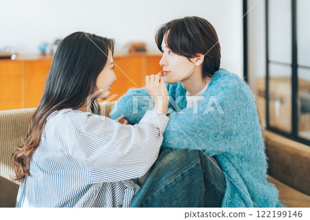 A woman applying lipstick to her boyfriend 122199146