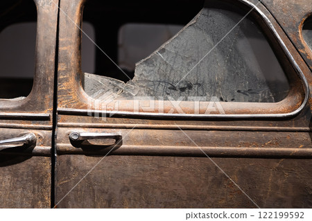 Rusty vintage car door with broken window glass Rusty vintage car door with broken window glass 122199592