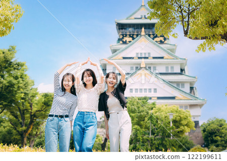 Women's trip A woman who poses in front of the castle tower of Osaka Castle Women's trip A woman who poses in front of the castle tower of Osaka Castle 122199611