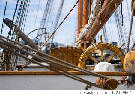 Wooden ship wheel and rigging details 122199664