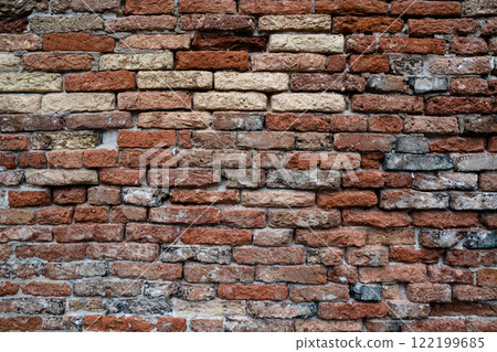 Rustic red brick wall with textured surfaces 122199685