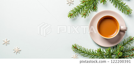 Cup of coffee surrounded by pine branches and snowflakes on light surface, festive winter theme, winter banner background., warm drink, Christmas mood, cozy decoration 122200391