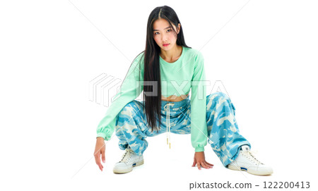 Trendy young Asian woman posing in colorful outfit on white background, stylish long hair, modern casual look, sporty clothing, urban fashion, youthful style, energetic pose 122200413