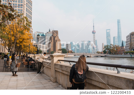 woman traveler visiting in Shanghai, China. Happy Female Tourist sightseeing Oriental Pearl Tower and Waibaidu Bridge view. landmark and popular for tourism attractions. Travel and vacation concept woman traveler visiting in Shanghai, China. Happy Female Tourist sightseeing Oriental Pearl Tower and Waibaidu Bridge view. landmark and popular for tourism attractions. Travel and vacation concept 122200433