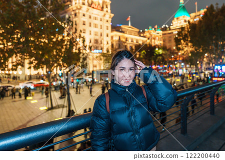 woman traveler visiting in Shanghai, China. Happy Female Tourist sightseeing Shanghai view in The Bund of Shanghai at night. landmark and popular for tourism attractions. Travel and Vacation concept woman traveler visiting in Shanghai, China. Happy Female Tourist sightseeing Shanghai view in The Bund of Shanghai at night. landmark and popular for tourism attractions. Travel and Vacation concept 122200440