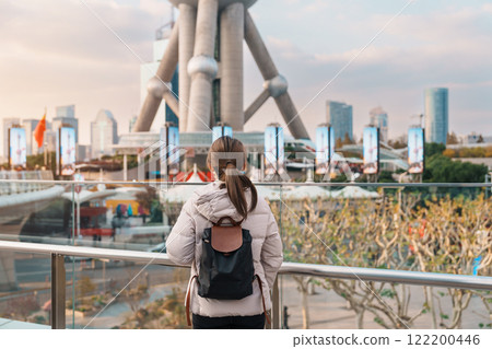 woman traveler visiting in Shanghai, China. Happy Female Tourist sightseeing Shanghai Oriental Pearl Tower view in Lujiazui. landmark and popular for tourism attractions. Travel and Vacation concept woman traveler visiting in Shanghai, China. Happy Female Tourist sightseeing Shanghai Oriental Pearl Tower view in Lujiazui. landmark and popular for tourism attractions. Travel and Vacation concept 122200446