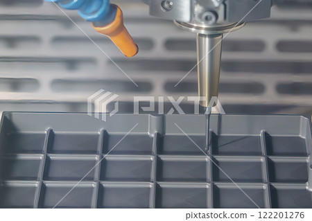The CNC milling machine cutting the graphite electrode parts with solid ball nose end mill tools. 122201276