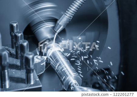 The lathe machine finish cut metal shaft parts with liquid coolant method in the light blue scene. The lathe machine finish cut metal shaft parts with liquid coolant method in the light blue scene. 122201277