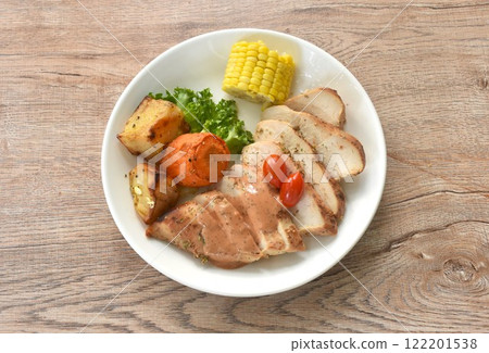 grilled slice chicken steak dressing gravy sauce with lettuce and boiled potato couple corn on plate grilled slice chicken steak dressing gravy sauce with lettuce and boiled potato couple corn on plate 122201538