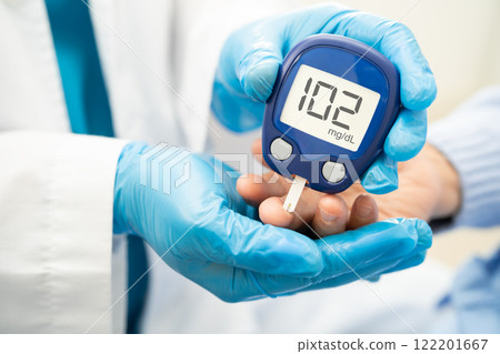 Doctor check diabetes from finger blood sugar level with finger lancet. Doctor check diabetes from finger blood sugar level with finger lancet. 122201667