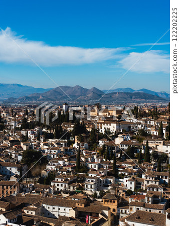 Granada city and towering mountains 122202225