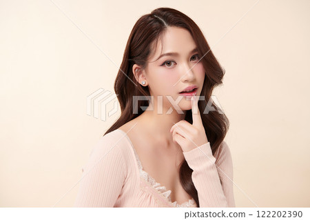 Beautiful young asian woman with clean fresh skin on beige background, Face care, Facial treatment, Cosmetology, beauty and spa, Asian women portrait. 122202390