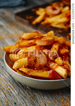 german currywurst and fries on a bowl 122203170