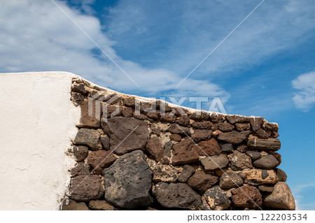 Detail of a white and stone wall, La Graciosa, Spain 122203534