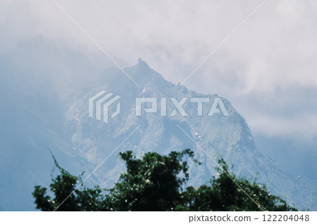 Mountain peaks shrouded in clouds Mountain peaks shrouded in clouds 122204048