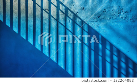 Minimalistic background with shadow on blue wall. Plaster texture 122204098