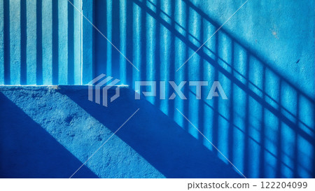 Minimalistic background with shadow on blue wall. Plaster texture 122204099