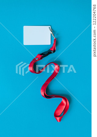 White plastic badge, red Lanyard with blank space mock up isolated on blue background White plastic badge, red Lanyard with blank space mock up isolated on blue background 122204768