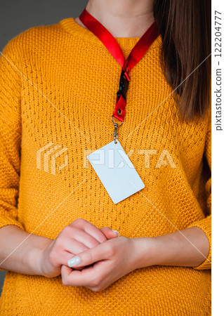 Woman holding badge name tag, with blank space mock up 122204777