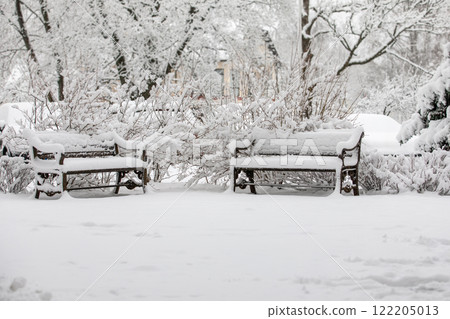 Snowy benches in the park, winter view with lots of snow Snowy benches in the park, winter view with lots of snow 122205013