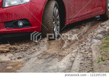 Car stuck in the mud, car wheel in dirty puddle, rough terrain 122205195