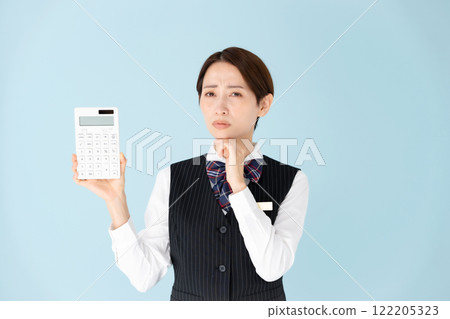 Woman in uniform, calculator, worries Woman in uniform, calculator, worries 122205323