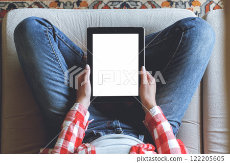 Woman using her tablet with blank of screen Woman using her tablet with blank of screen 122205605