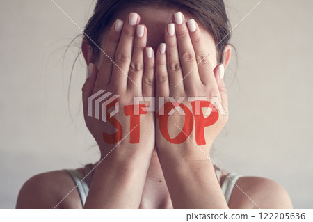 Concept photo about domestic violence young woman 122205636