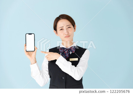 Woman in uniform, smartphone, worries 122205676